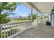 Spacious front porch with seating, a beautiful railing, columns, and a scenic view of a pond at 1601 Bourne Xing, Mount Pleasant, SC 29466