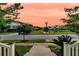 View from the front steps showcasing the landscaped yard and quiet street with pond views at 1601 Bourne Xing, Mount Pleasant, SC 29466