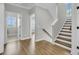 Hallway with hardwood floors, staircase with wooden steps, and open doors to rooms at 1601 Bourne Xing, Mount Pleasant, SC 29466