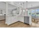 Open-concept kitchen with white cabinets, granite countertops, stainless steel appliances, and pendant lighting over the island at 1601 Bourne Xing, Mount Pleasant, SC 29466