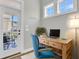 Charming home office space featuring a wood desk, blue accent chair, and natural light from the window at 1601 Bourne Xing, Mount Pleasant, SC 29466