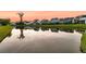 Picturesque pond view showcasing neighborhood homes and tree reflections during a beautiful sunset at 1601 Bourne Xing, Mount Pleasant, SC 29466