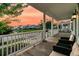 Inviting front porch with comfortable seating and serene views of the neighborhood and a tranquil pond at 1601 Bourne Xing, Mount Pleasant, SC 29466