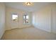 Bright bedroom featuring carpet floors, a ceiling light, and an exterior door to the back yard at 171 Threaded Fern Lndg, Summerville, SC 29485
