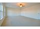 Bright bedroom featuring neutral carpeting, a ceiling fan, and three closets or access doors at 171 Threaded Fern Lndg, Summerville, SC 29485