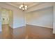 Elegant dining area with hardwood floors, wainscoting, and a view into the bright kitchen at 171 Threaded Fern Lndg, Summerville, SC 29485