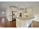 Modern kitchen featuring stainless steel appliances, white cabinets, hardwood floors, and a large island at 171 Threaded Fern Lndg, Summerville, SC 29485