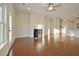 Spacious living room with a fireplace, hardwood floors, a ceiling fan, and a view of the adjacent kitchen at 171 Threaded Fern Lndg, Summerville, SC 29485
