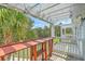 Outdoor balcony with wooden floors, railing, string lights, and a bar at 1723 Brittlebush Ln, Johns Island, SC 29455