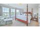 Bedroom with decorative bed, window views and a cushioned sitting chair at 1723 Brittlebush Ln, Johns Island, SC 29455