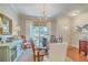 Formal dining room showcasing hardwood floors, a chandelier, and views of the foyer at 1723 Brittlebush Ln, Johns Island, SC 29455
