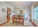 Formal dining room showcasing hardwood floors, a chandelier, and views of the kitchen at 1723 Brittlebush Ln, Johns Island, SC 29455