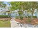 Charming two-story condo with light-blue siding, manicured bushes, and a welcoming front entrance at 1723 Brittlebush Ln, Johns Island, SC 29455