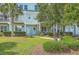 Charming two-story condo with light-blue siding, manicured bushes, and a welcoming front entrance at 1723 Brittlebush Ln, Johns Island, SC 29455
