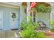 Welcoming front porch features a chair, plants, and patriotic decorations at 1723 Brittlebush Ln, Johns Island, SC 29455