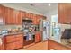 Updated kitchen features stainless appliances, granite counters, and warm wood cabinetry at 1723 Brittlebush Ln, Johns Island, SC 29455