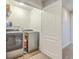 Laundry room with washer, dryer, shelving and wood-look vinyl flooring at 1723 Brittlebush Ln, Johns Island, SC 29455