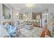 Open-concept living room with breakfast bar, wood floors, and neutral decor at 1723 Brittlebush Ln, Johns Island, SC 29455