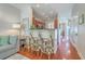 Open-concept living room with breakfast bar, wood floors, and neutral decor at 1723 Brittlebush Ln, Johns Island, SC 29455