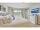 Bright main bedroom with a balcony, television and white dresser at 1723 Brittlebush Ln, Johns Island, SC 29455