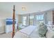 Spacious bedroom featuring a four-poster bed, sitting chair, and view of the water at 1723 Brittlebush Ln, Johns Island, SC 29455