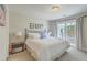 Bright, airy bedroom featuring a walk-out balcony and a wrought-iron bed frame at 1723 Brittlebush Ln, Johns Island, SC 29455