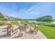Relaxing outdoor patio with fire pit and comfortable seating overlooking the scenic lake at 1723 Brittlebush Ln, Johns Island, SC 29455