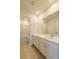A well-lit bathroom with a large mirror, sleek vanity, and tiled floors offers modern comfort at 175 Threaded Fern Lndg, Summerville, SC 29485