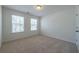 This is a bright, airy bedroom featuring carpeted floors and natural light from the double windows at 175 Threaded Fern Lndg, Summerville, SC 29485