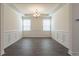 Formal dining room showcasing the tray ceiling, windows, wainscoting and hardwood floors at 175 Threaded Fern Lndg, Summerville, SC 29485