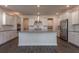 Open kitchen with white cabinets, stainless steel appliances, an island, and hardwood floors at 175 Threaded Fern Lndg, Summerville, SC 29485