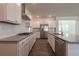 A kitchen with stainless steel appliances, white cabinets, granite countertops, and an island at 175 Threaded Fern Lndg, Summerville, SC 29485