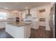 Bright kitchen with white cabinets, stainless steel appliances, granite countertops and a center island at 175 Threaded Fern Lndg, Summerville, SC 29485