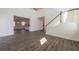 Open-concept living room with hardwood floors, staircase, and views into the kitchen at 175 Threaded Fern Lndg, Summerville, SC 29485