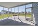 A screened porch with views of the backyard and pond offers a comfortable outdoor living space at 175 Threaded Fern Lndg, Summerville, SC 29485