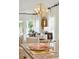 Inviting dining area with a modern chandelier, large windows, and comfortable seating at 1819 Nola Run, Summerville, SC 29485