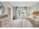 Serene main bedroom featuring neutral tones, ample natural light, and view of the water at 1819 Nola Run, Summerville, SC 29485