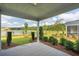 Covered patio boasts scenic views of the lake and landscaping at 1819 Nola Run, Summerville, SC 29485