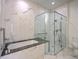 Bright bathroom features a modern glass shower, luxurious soaking tub, and stylish marble tile at 200 River Landing Dr # 307B, Charleston, SC 29492