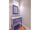 Stylish bathroom vanity with a unique mirror, marble countertop, and wood floors at 200 River Landing Dr # 307B, Charleston, SC 29492