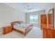 Cozy bedroom with neutral carpet, a large window, ceiling fan, and classic wood furniture at 200 River Landing Dr # 307B, Charleston, SC 29492
