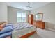 Comfortable bedroom with wooden furniture, ceiling fan and large window providing natural light at 200 River Landing Dr # 307B, Charleston, SC 29492