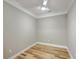 Neutral bedroom featuring a modern ceiling fan, trim, and wood-look floors at 200 River Landing Dr # 307B, Charleston, SC 29492