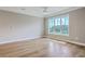 This bedroom features hardwood floors, a ceiling fan and a large window with neighborhood views at 200 River Landing Dr # 307B, Charleston, SC 29492