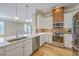 Modern kitchen features stainless steel appliances, white cabinets, granite countertops and hardwood floors at 200 River Landing Dr # 307B, Charleston, SC 29492