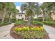 Professionally landscaped grounds with a flower bed and trimmed bushes around condo building at 200 River Landing Dr # 307B, Charleston, SC 29492