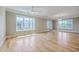 Spacious living room boasts hardwood floors, large windows, and access to a private balcony at 200 River Landing Dr # 307B, Charleston, SC 29492