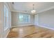 This living room features hardwood floors, a modern light fixture, and access to a private balcony at 200 River Landing Dr # 307B, Charleston, SC 29492