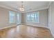 Bright living room with hardwood floors, a modern light fixture, and large windows and balcony at 200 River Landing Dr # 307B, Charleston, SC 29492