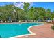 Inviting outdoor swimming pool with lounge chairs and mature trees at 200 River Landing Dr # 307B, Charleston, SC 29492